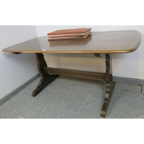 769 - A mid-century elm refectory dining table by Ercol, on shaped supports with a middle stretcher. 
H72c... 