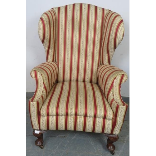 773 - A 19th century Georgian design wingback armchair, reupholstered in striped material with brass studs... 