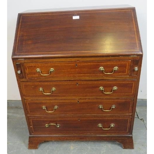 775 - An Edwardian mahogany bureau of small proportions, strung with satinwood and ebony, the fall-front o... 