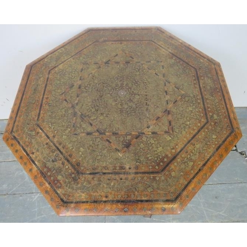 781 - An early 20th century Islamic hardwood octagonal occasional table, featuring brass and parquetry inl... 