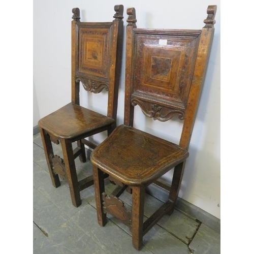 786 - A pair of 17th century and later cherrywood Tyrolean his and hers inlaid hall chairs, the back panel... 