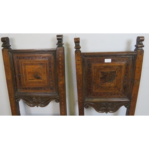 786 - A pair of 17th century and later cherrywood Tyrolean his and hers inlaid hall chairs, the back panel... 