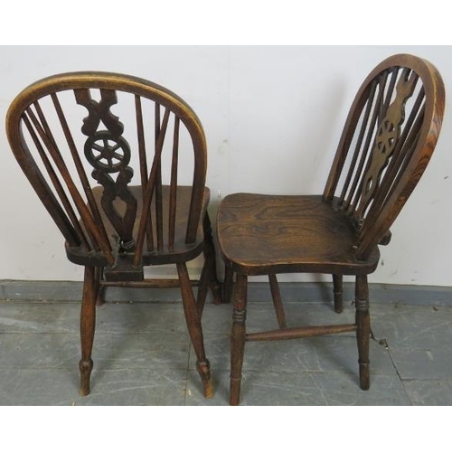 792 - A set of six vintage elm and beech wheel-back dining chairs, on turned canted supports with an ‘H’ s... 