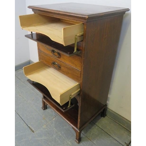 800 - An Edwardian mahogany music cabinet, housing five long drawers with pressed brass handles, above an ... 