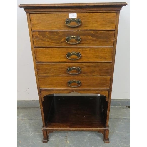 800 - An Edwardian mahogany music cabinet, housing five long drawers with pressed brass handles, above an ... 