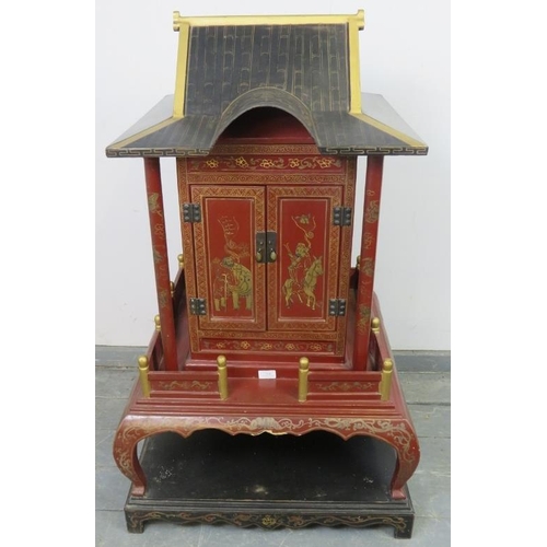 802 - A vintage Chinese temple cabinet, the red lacquer hand painted with traditional scenes and gold acce... 