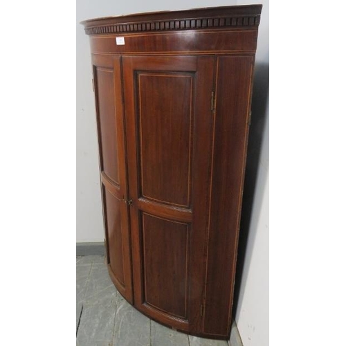 803 - A George III mahogany wall hanging corner cupboard, with dentil cornice and strung with satinwood, t... 