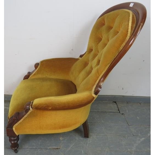 805 - A Victorian mahogany spoonback chair, upholstered in gold buttoned material with braid trim, on tape... 