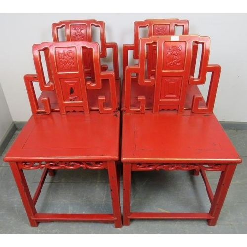 806 - A set of four early 20th century Chinese cinnabar dining chairs in red lacquer with gold accents, fe... 