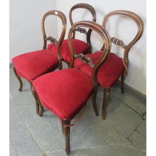 807 - A set of four Victorian rosewood balloon back dining chairs, with carved and pierced backs, upholste... 