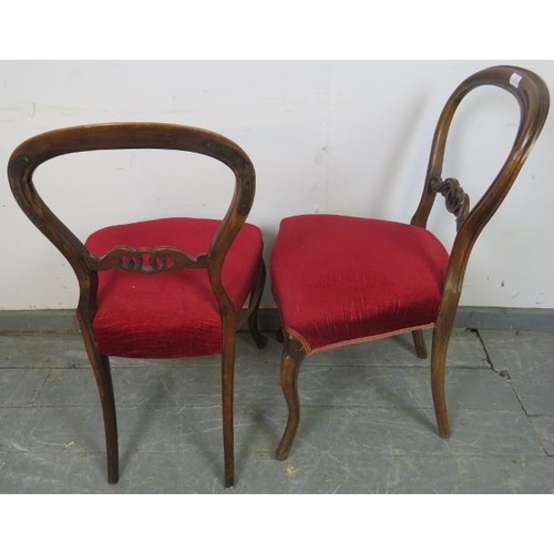 807 - A set of four Victorian rosewood balloon back dining chairs, with carved and pierced backs, upholste... 