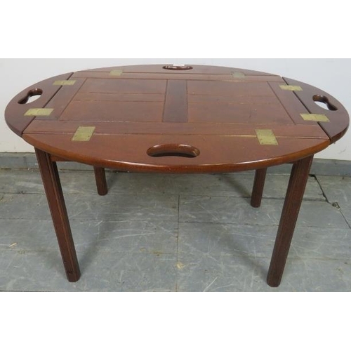 808 - A reproduction Georgian-style mahogany butler’s tray table, the tray with folding sided and brass hi... 