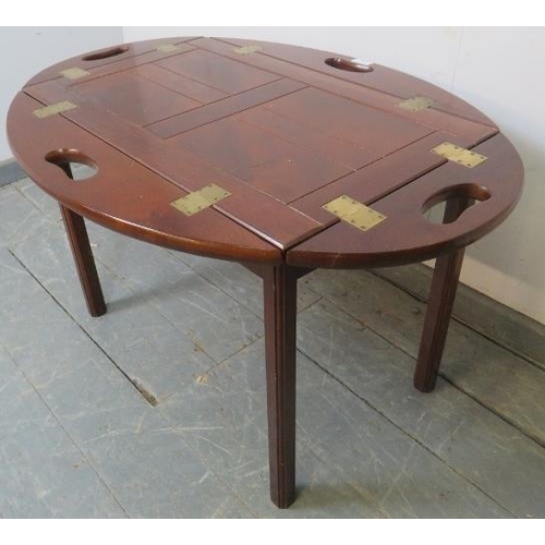 808 - A reproduction Georgian-style mahogany butler’s tray table, the tray with folding sided and brass hi... 