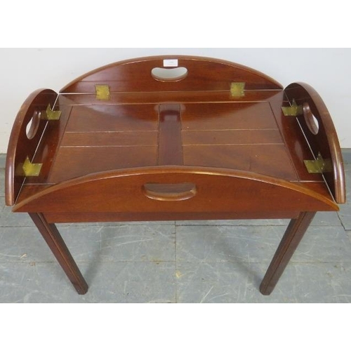 808 - A reproduction Georgian-style mahogany butler’s tray table, the tray with folding sided and brass hi... 