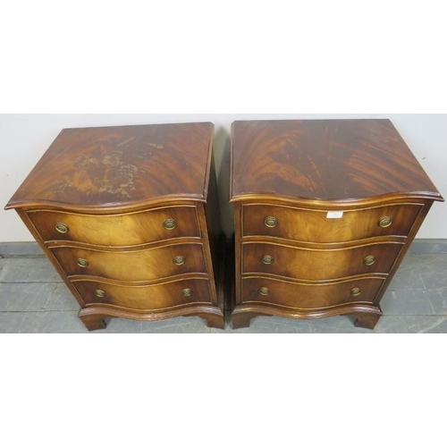 809 - A pair of reproduction Georgian-style flame mahogany serpentine fronted bedside chests, each housing... 