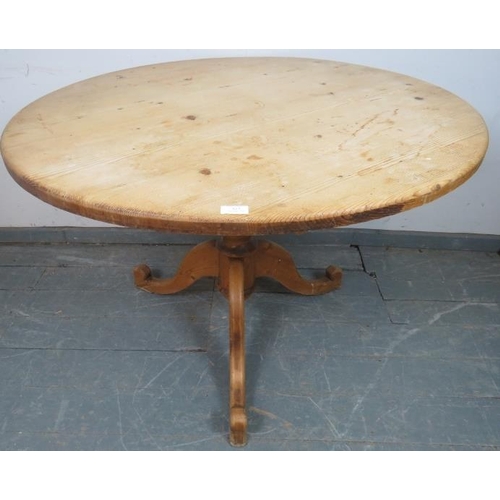 813 - A vintage stripped pine circular kitchen table, on a baluster column with tripod supports. 
H73cm Di... 