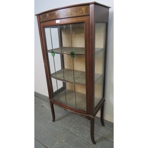 814 - An Edwardian mahogany bow fronted glazed display cabinet, with marquetry inlay and strung with satin... 