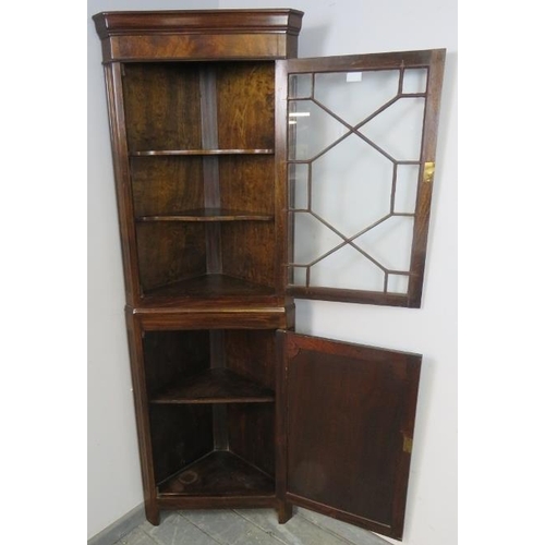 817 - A tall Edwardian Georgian Revival corner cupboard, the top with astral glazed door and two fitted sh... 