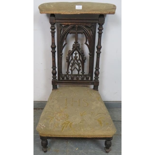 818 - A Victorian mahogany prayer chair (prix-dieux), with carved and pierced backrest in an ecclesiastica... 