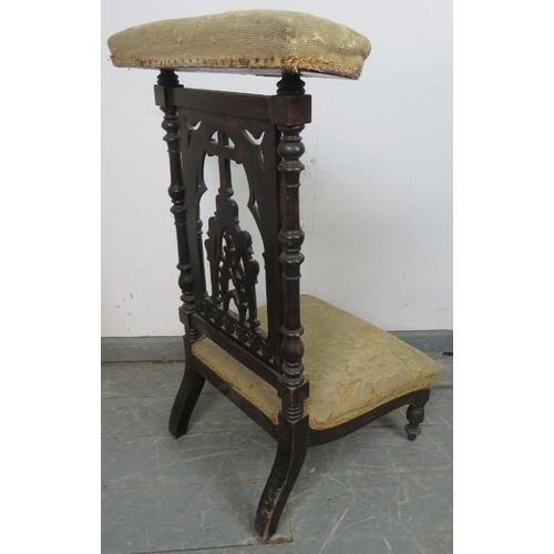 818 - A Victorian mahogany prayer chair (prix-dieux), with carved and pierced backrest in an ecclesiastica... 