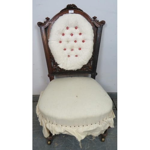 819 - A Victorian mahogany bedroom chair, with fluted bun finials and acanthus carved and pierced back, on... 