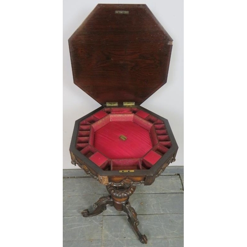 828 - A Victorian rosewood octagonal trumpet/work table, with fitted interior, featuring carved frieze and... 