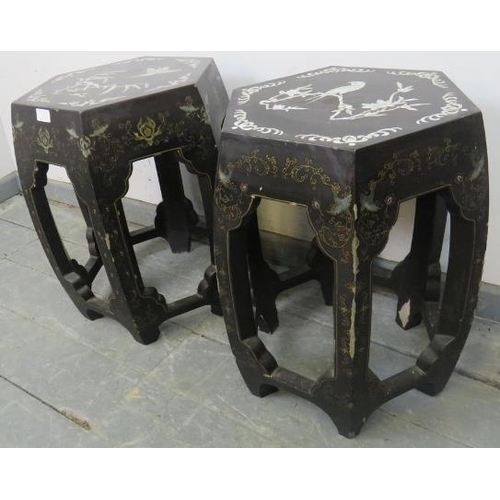 836 - A near pair of vintage Chinese black lacquer barrel stools, the tops with mother of pearl inlay depi... 