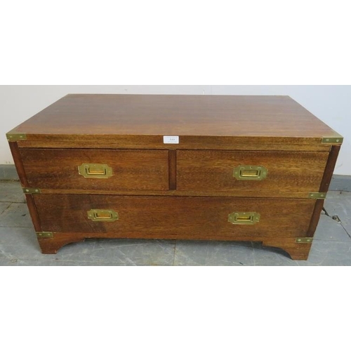 840 - A vintage mahogany campaign coffee table, with brass mounts and handles to either side, housing two ... 