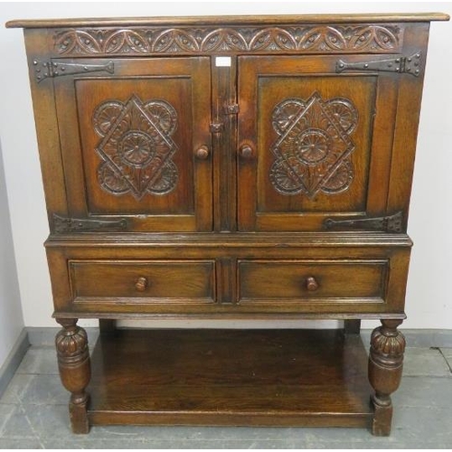 841 - A vintage oak court cupboard of small proportions in the 16th century taste, with carved frieze abov... 