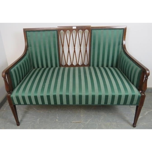 842 - An Edwardian mahogany two-seater sofa featuring a pierced lattice back and strung with satinwood and... 