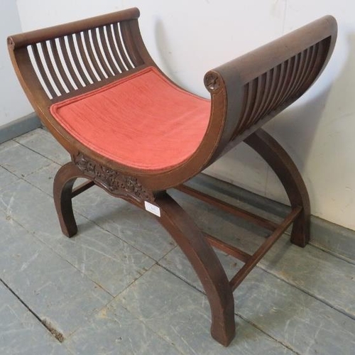 845 - An Edwardian mahogany ‘X-frame’ music stool strung with satinwood and featuring relief foliate carvi... 