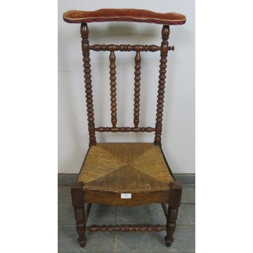 849 - A 19th century Arts & Crafts walnut rush-seated prix-dieux with velvet armrest and ball turned uprig... 