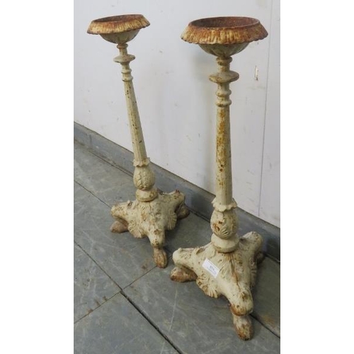 858 - A pair of Victorian floor-standing cast iron candle sticks painted white, on ogee supports. 
H54cm W... 