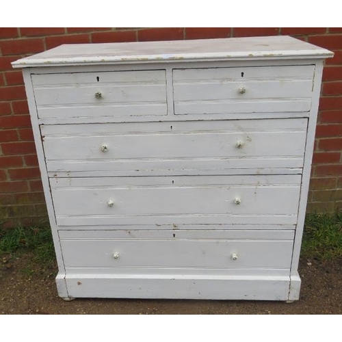 863 - An antique pine chest of two short over three long graduated drawers painted distressed white, on a ... 