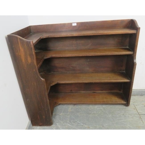 864 - An early 20th century oak ecclesiastical low corner bookcase, of four graduated open shelves. 
H87cm... 