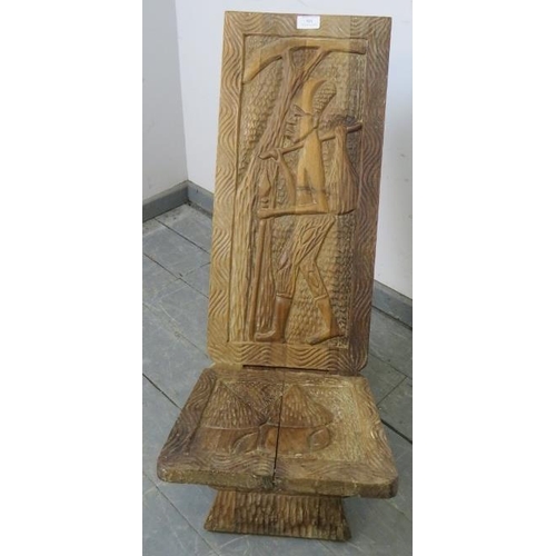 866 - A vintage African hardwood birthing stool, with relief carving depicting a tribal figure. H75 W30 D8... 