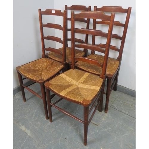 868 - A set of four 19th century oak ladderback dining chairs, with rush seats, on tapering supports with ... 