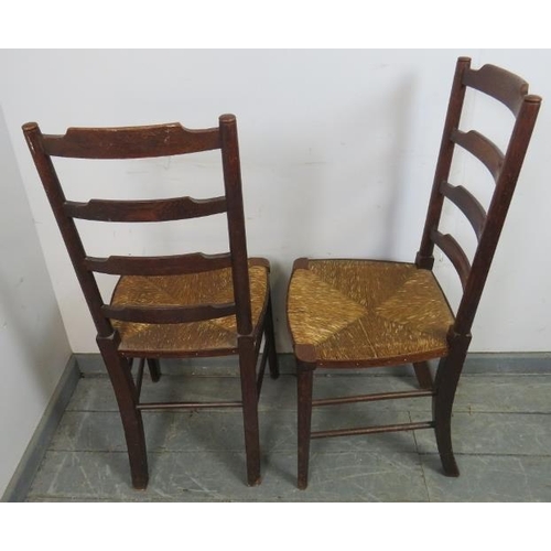 868 - A set of four 19th century oak ladderback dining chairs, with rush seats, on tapering supports with ... 