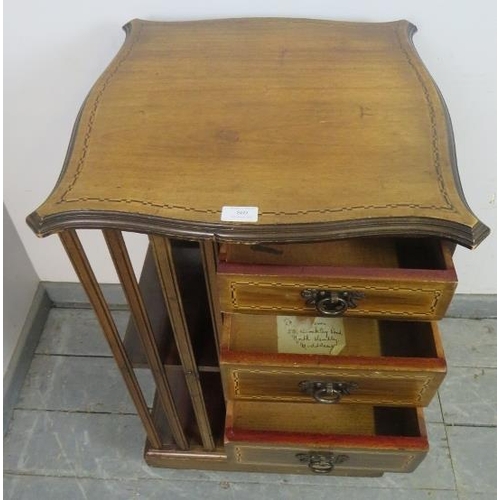 869 - An Edwardian mahogany revolving bookcase, featuring parquetry inlay, with three short drawers and an... 