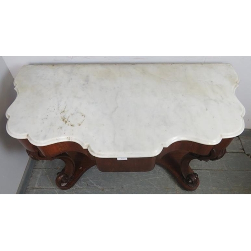 872 - A Victorian mahogany console table, with a white marble shaped top, above a central blind drawer, on... 