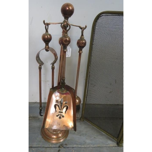 874 - An Edwardian copper and brass fireside companion set, together with a three-section brass and wire m... 