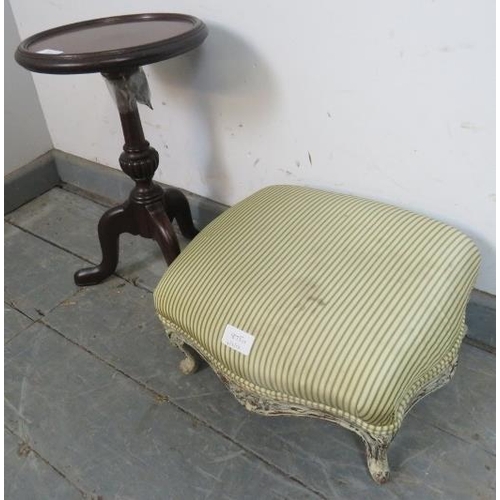 875 - A small Victorian footstool, reupholstered in striped material, on carved ogee supports painted dist... 