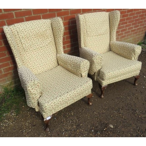 878 - A pair of vintage Parker Knoll style wingback armchairs upholstered in foliate patterned cream mater... 