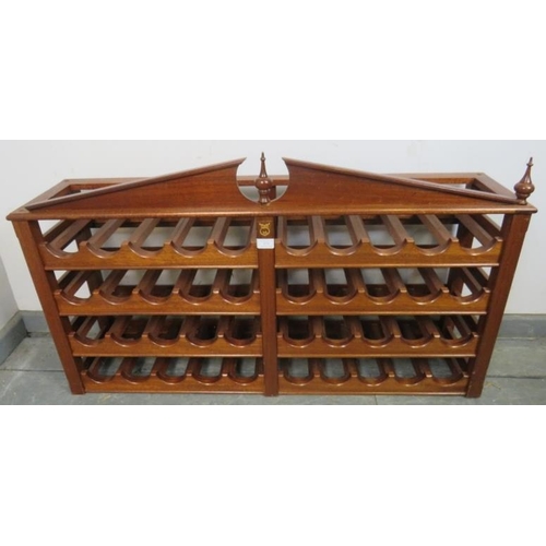 879 - A mahogany wine rack (capacity 40 bottles) with turned finials and central owl motif. 
H62cm W106cm ... 