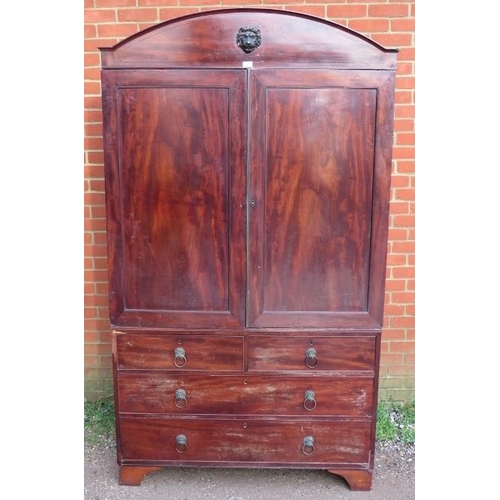 882 - A Regency Period mahogany linen press, the cornice with ebony inlay and central lion mask, above a c... 