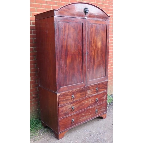 882 - A Regency Period mahogany linen press, the cornice with ebony inlay and central lion mask, above a c... 