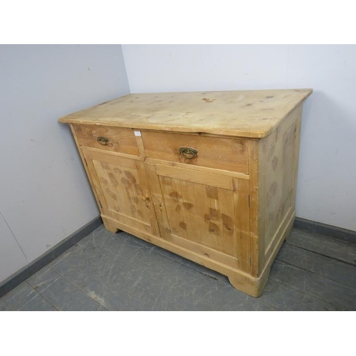 889 - An antique stripped pine sideboard, housing two short drawers above a cupboard with loose shelf, on ... 