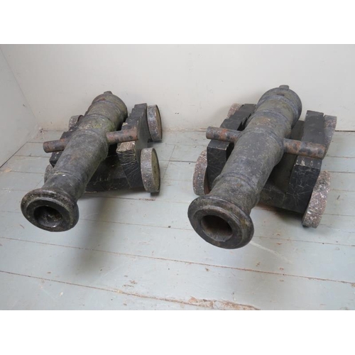 891 - A fantastic pair of early 19th Century naval deck cannons each with raised crests and mounted on lat... 