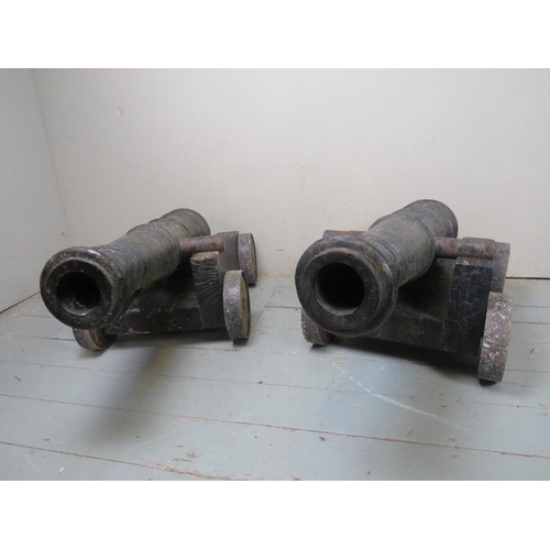 891 - A fantastic pair of early 19th Century naval deck cannons each with raised crests and mounted on lat... 