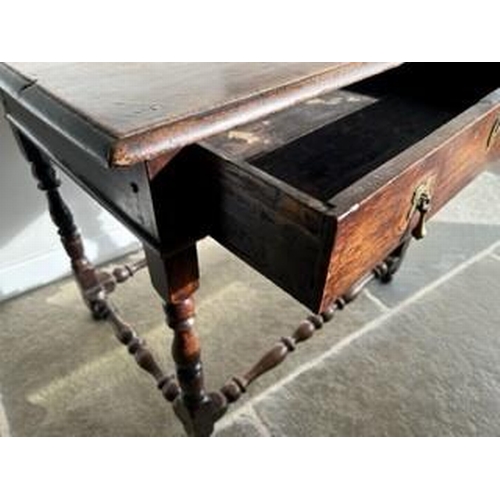 894 - An early 18c Country oak side table (1740 ) with a long frieze drawer and brass drop handles and esc... 